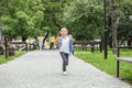 Child girl goes from school with a backpack. The concept of school, study, education, friendship Royalty Free Stock Photo