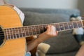 Child girl hand playing guitar in room - leisure music and hobby concept Royalty Free Stock Photo