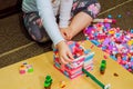 Child girl having fun and build of bright plastic construction blocks. Royalty Free Stock Photo