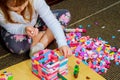 Child girl having fun and build of bright plastic construction blocks. Royalty Free Stock Photo