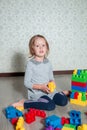 Child girl having fun and build of bright plastic construction blocks Royalty Free Stock Photo