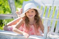 Child girl having fun on a swing. Adorable little girl having fun on a swing outdoor. Close up portrait of a beautiful