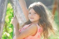 Child girl having fun on a swing. Adorable little girl having fun on a swing outdoor. Dreamy kids face.