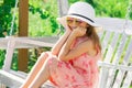 Child girl having fun on a swing. Adorable little girl having fun on a swing outdoor. Fashion child in summer straw hat