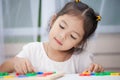 Child girl having fun to play and learn magnetic alphabets