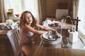 Child girl helps mother at home and wash dishes in kitchen. Casual lifestyle in real interior