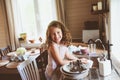 Child girl helps mother at home and wash dishes in kitchen. Casual lifestyle in real interior