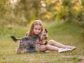 Child girl with her little Yorkshire terrier dog in the park Royalty Free Stock Photo