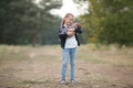 Child girl with her newborn brother on walk in park.