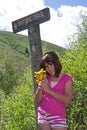 Child (girl) hiking and picking wildflowers. Royalty Free Stock Photo