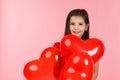 Child girl holding red heart shaped balloon Royalty Free Stock Photo