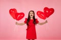 Child girl holding red heart shaped balloon Royalty Free Stock Photo