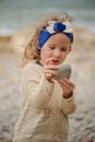 Child girl holding stone with focus on hands Royalty Free Stock Photo