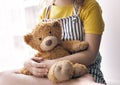 Child girl holding teddy bear. Plush toy closeup