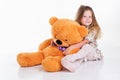 Child girl is hugging her teddy bear Royalty Free Stock Photo