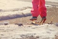 Child girl jumping in spring puddle with big splash Royalty Free Stock Photo