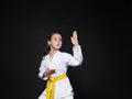 Child girl in karate suit with yellow belt show stance Royalty Free Stock Photo