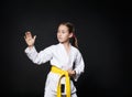 Child girl in karate suit with yellow belt show stance Royalty Free Stock Photo