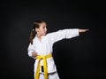 Child girl in karate suit with yellow belt show stance Royalty Free Stock Photo