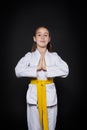 Child girl in karate suit with yellow belt show stance Royalty Free Stock Photo