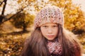 Child girl in knitted scarf and sweater on autumn walk in forest Royalty Free Stock Photo