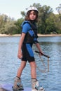 Child girl learning to ride a wakeboard. Royalty Free Stock Photo