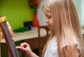 Child girl learning to write on drawing board at home Royalty Free Stock Photo