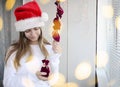 Child girl with long hair open small bags of gifts surprises advent calendar in her hands. Happy waiting of Christmas and New Year Royalty Free Stock Photo