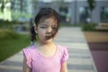 Child girl looking at the camera.  The child is out for a walk.  Black hair matted in the wind. Royalty Free Stock Photo