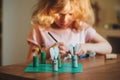 Child girl making easter craft tic tac toe game at home Royalty Free Stock Photo