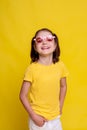 child girl in mockup yellow T-shirt on yellow background. summer banner crazy seasonal sale of children clothes Royalty Free Stock Photo