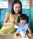 Child girl and mother eating ice cream waffles Royalty Free Stock Photo