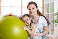 Child girl and mother with fitness ball Royalty Free Stock Photo