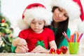 Child girl and mother writing letter to Santa Royalty Free Stock Photo