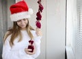 Child girl with long hair open small bags of gifts surprises advent calendar in her hands. Happy waiting of Christmas and New Year Royalty Free Stock Photo