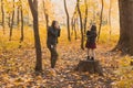 Mother photographer takes pictures of a her daughter in the park in autumn. Hobbies, photo art and leisure concept. Royalty Free Stock Photo