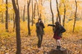 Mother photographer takes pictures of a her daughter in the park in autumn. Hobbies, photo art and leisure concept. Royalty Free Stock Photo