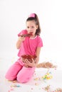 Girl in pink in the studio eating a big spoon jam Royalty Free Stock Photo