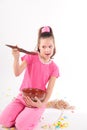 Girl in pink in the studio eating a big spoon jam Royalty Free Stock Photo