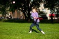 Child girl playing baseball in park