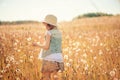 Child girl playing with blow balls on summer field