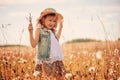 Child girl playing with blow balls on summer field