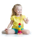 Child girl playing with color pyramid toy Royalty Free Stock Photo