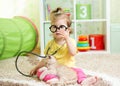 Child Girl Playing Doctor With A Cat In Nursery Royalty Free Stock Photo