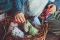 Child girl playing with easter eggs and handmade decorations in cozy country house