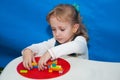 The child concentrates at the game table in the designer