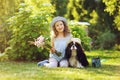 Child girl playing with her spaniel dog in summer garden Royalty Free Stock Photo