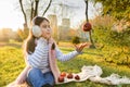 Child girl playing with red apples in sunny autumn park Royalty Free Stock Photo