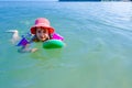 Girl is wearing inflatable armbands, learning to swim in the sea Royalty Free Stock Photo