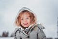 Child girl playing with snow on the walk in winter forest Royalty Free Stock Photo